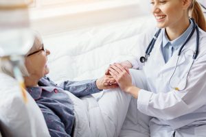 Smiling,Patient,Keeping,Hand,Of,Doctor