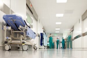 Blurred figures of people with medical uniforms in hospital corridor