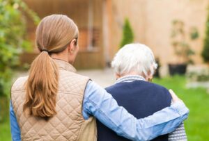 38190570 - young carer walking with the elderly woman in the park