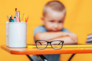 Boy,Sitting,Ubfocused,Glasses,In,Focus.,Concept,Problem,Of,Ophthalmology