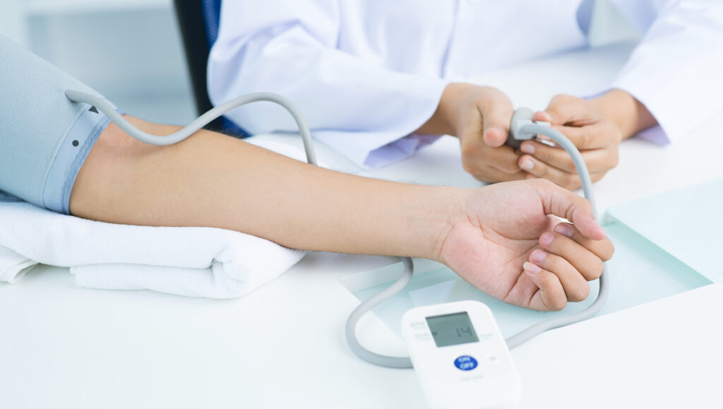 Close-up of female hand in blood pressure gauge